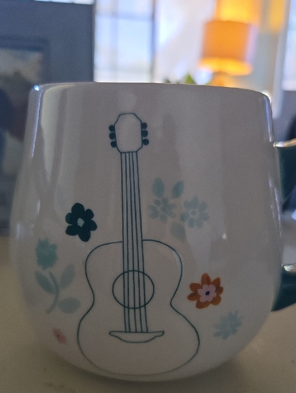 Dolly Parton stoneware mug features an embossed acoustic guiitar